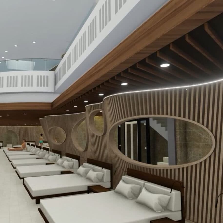 Eine moderne Indoor-Lounge mit mehreren weißen Matratzen, die entlang einer geschwungenen Holzwand mit ovalen Fenstern angeordnet sind. Darüber ist ein Balkon im zweiten Stock mit weißem Geländer zu sehen.