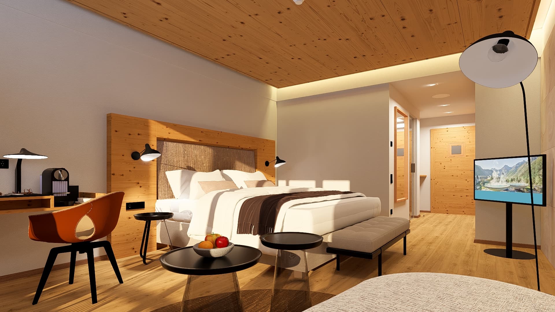 Modernes Hotelzimmer mit einem Queensize-Bett, einem Kopfteil aus Holz, einem kleinen Couchtisch mit Obst, einem Schreibtisch mit Stuhl und einem an der Wand montierten Fernseher.